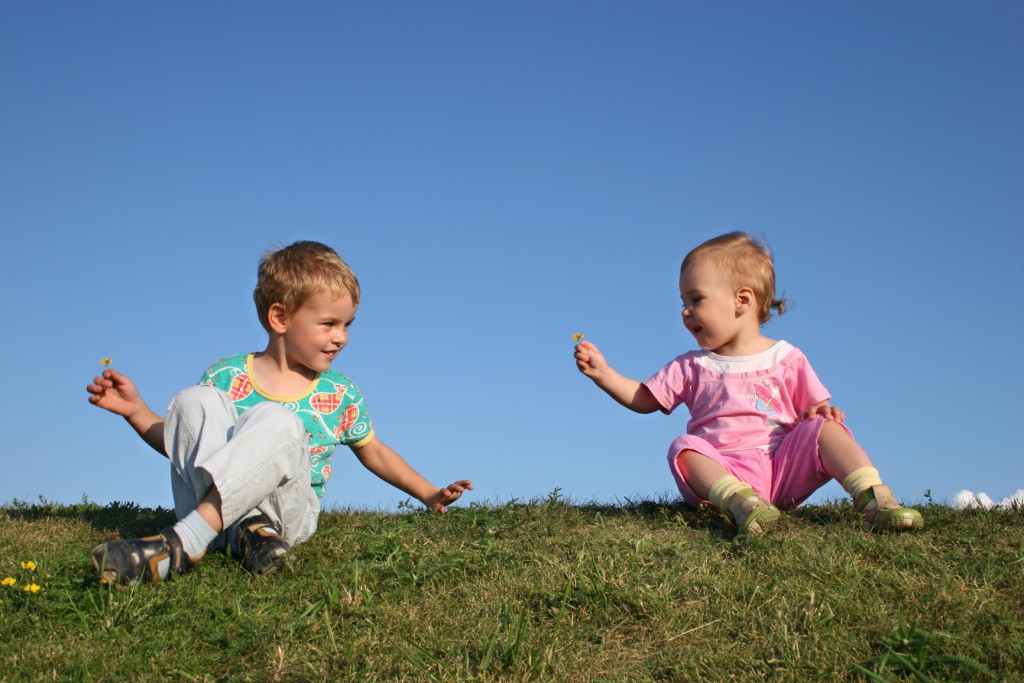 children on grass with flowers
